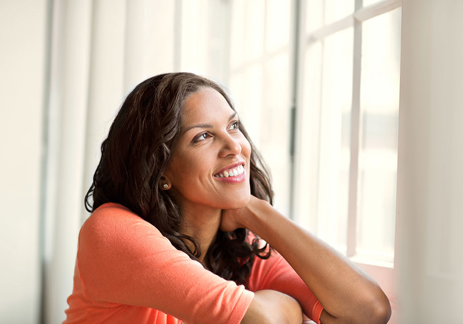 smiling woman looking out window
